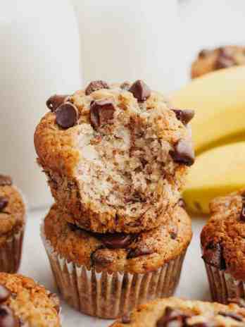 Banana chocolate chip muffins stacked on top of each other.