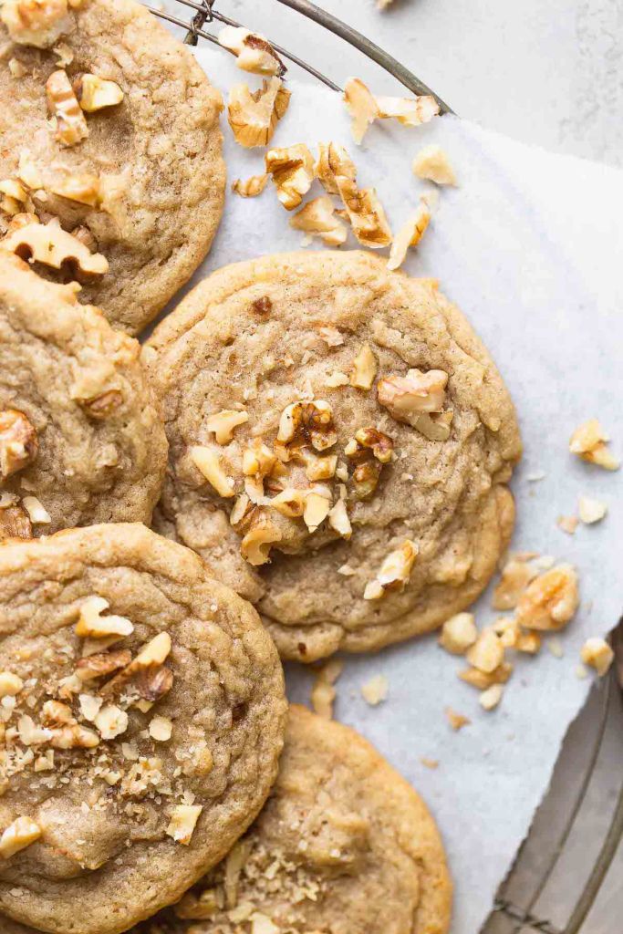 A close-up overhead view of banana nut cookies on a wire cooling rack. 