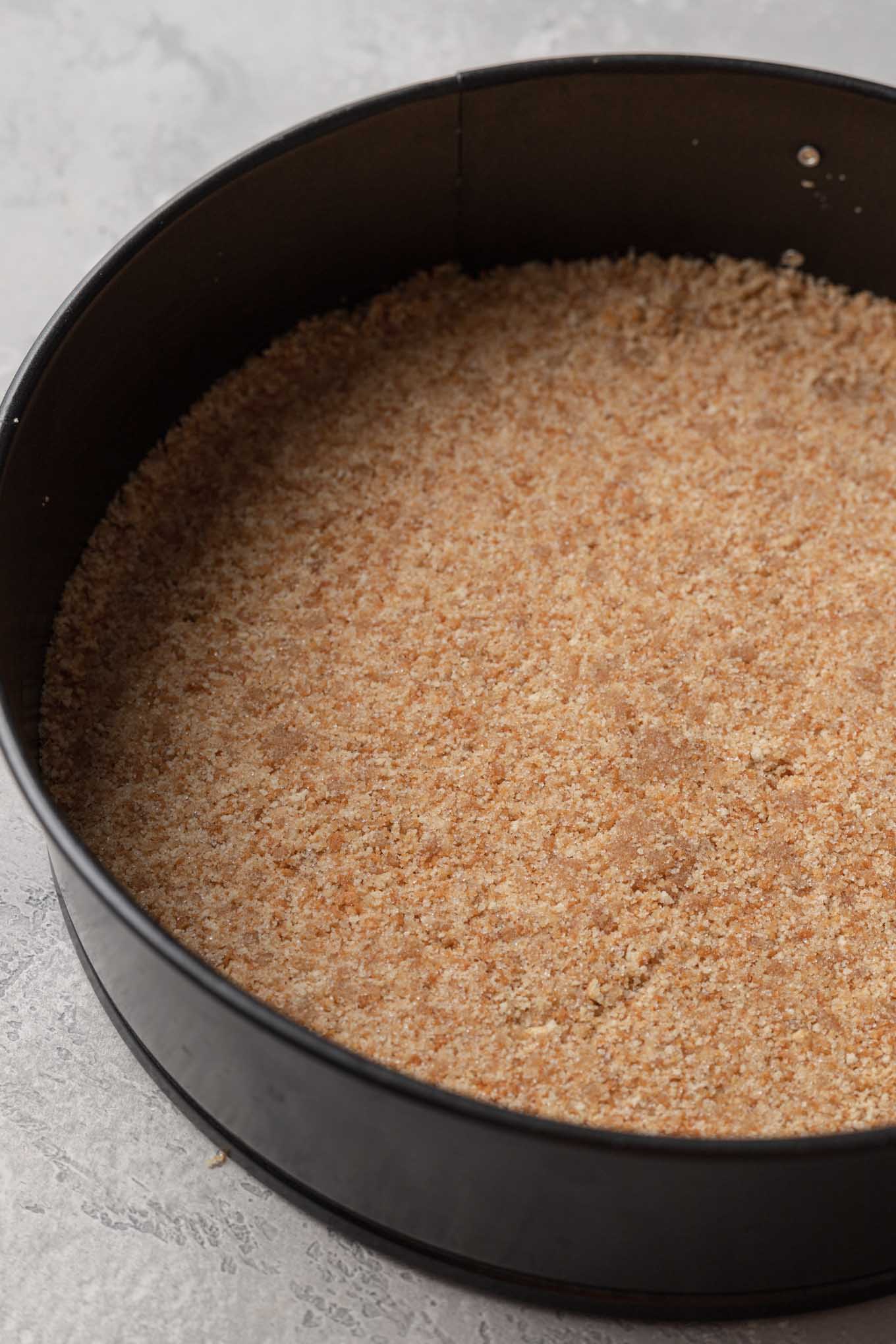 A Nilla Wafer crust pressed into a springform pan.