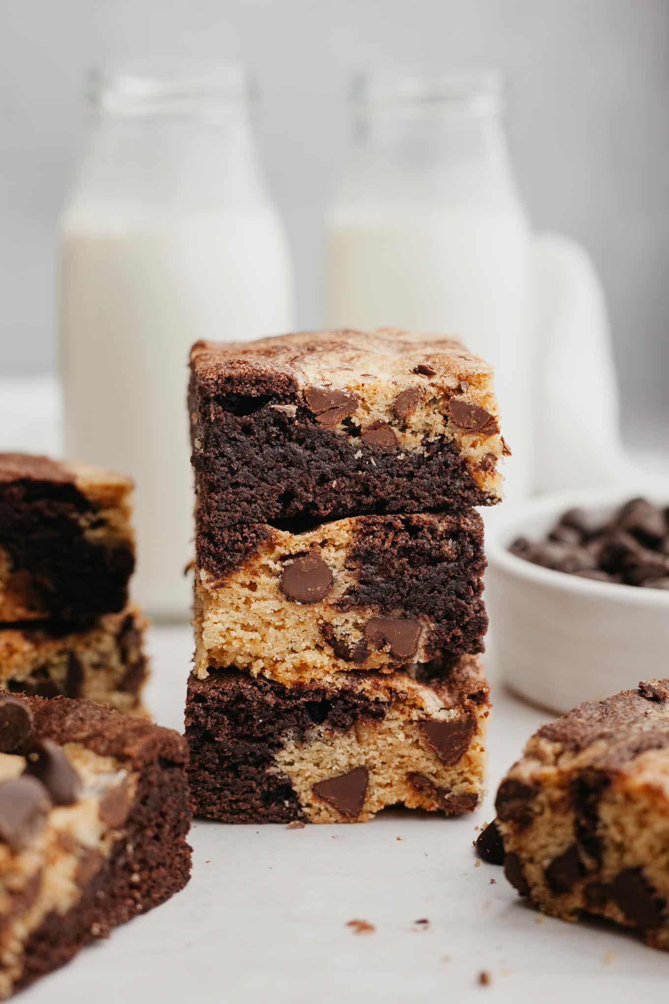 A stack of three brookies, with glass milk jugs in background.