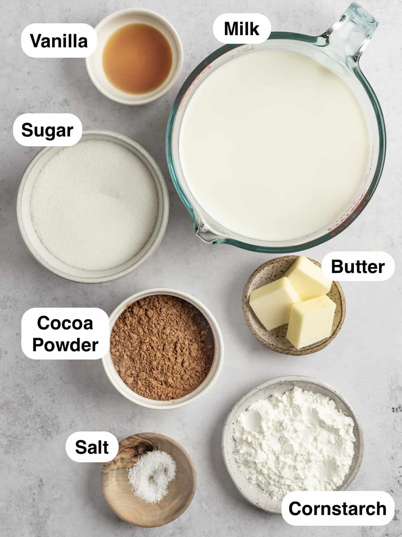 An overhead view of the ingredients needed to make chocolate pudding from scratch. 