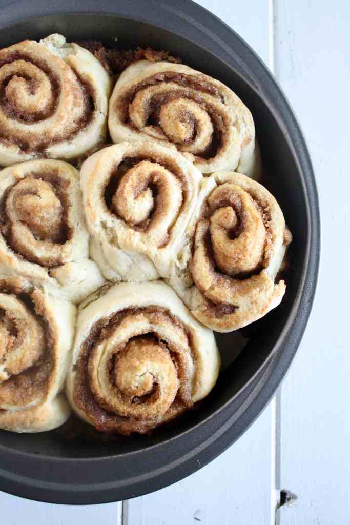 Unfrosted no yeast cinnamon rolls in a round baking pan. 