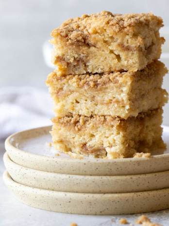 A stack of coffee cake pieces showing the cake and streusel layers.