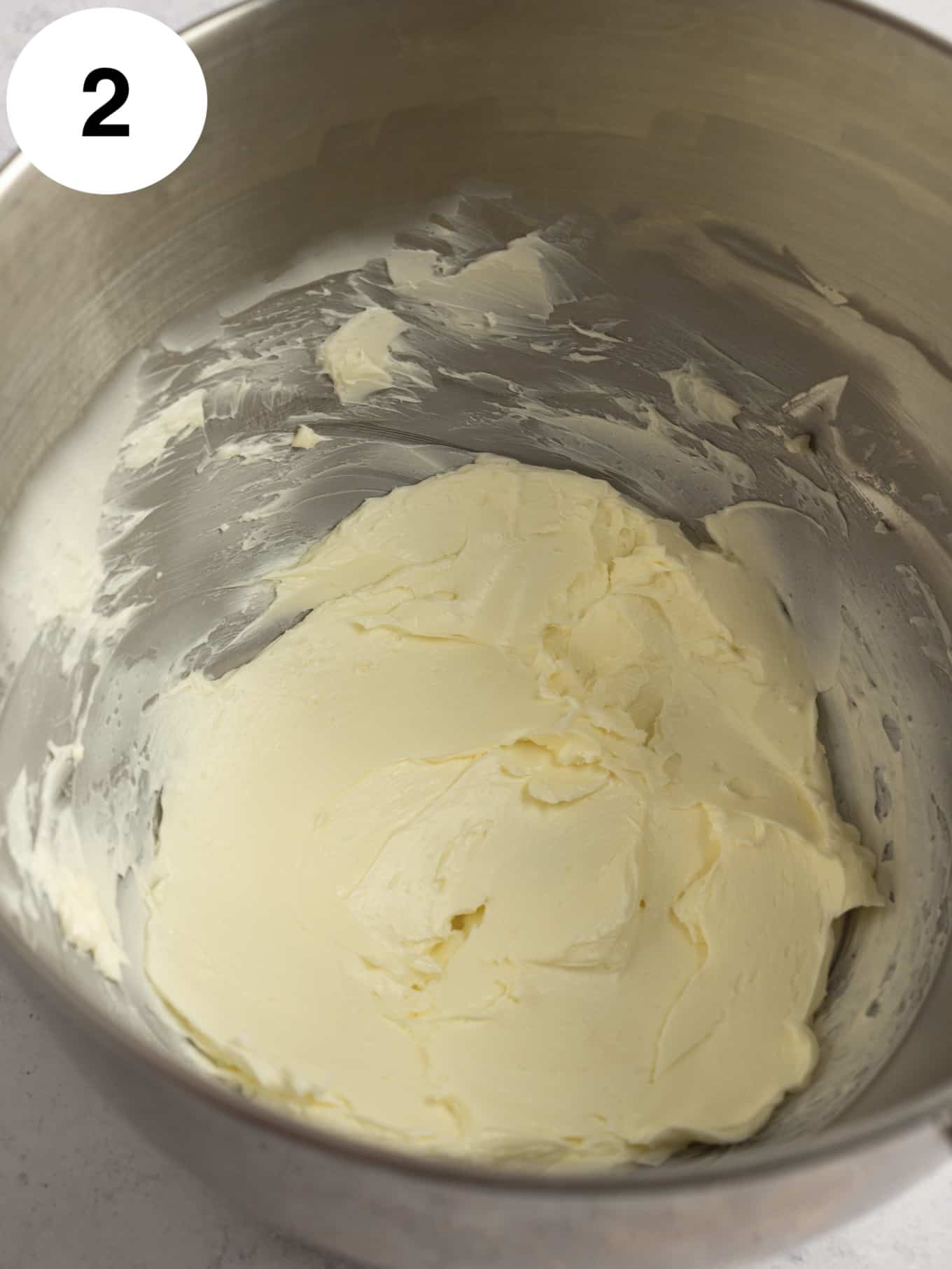 Beaten butter in the bowl of a stand mixer. 
