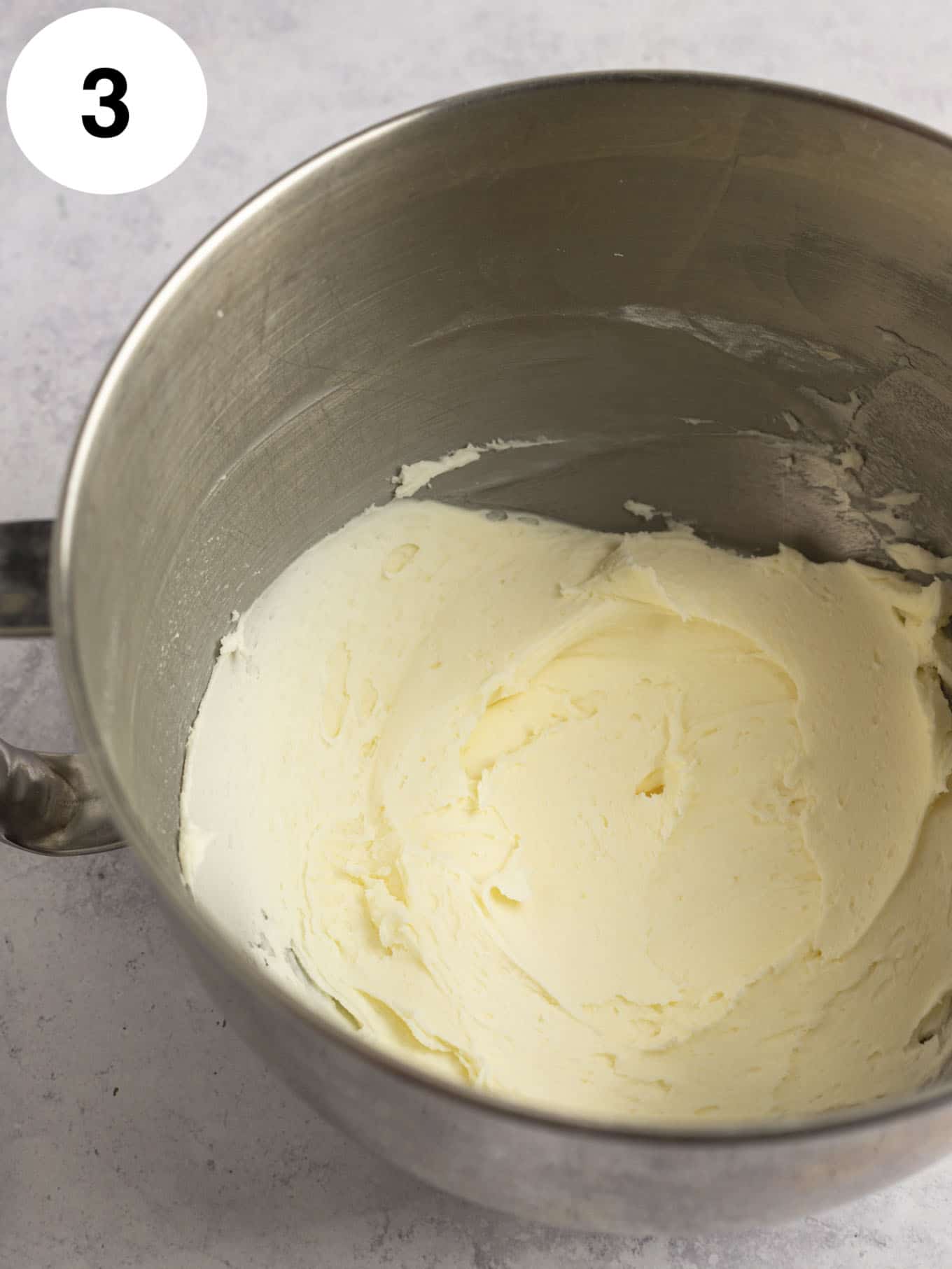 Butter and powdered sugar beaten together in the bowl of a stand mixer. 