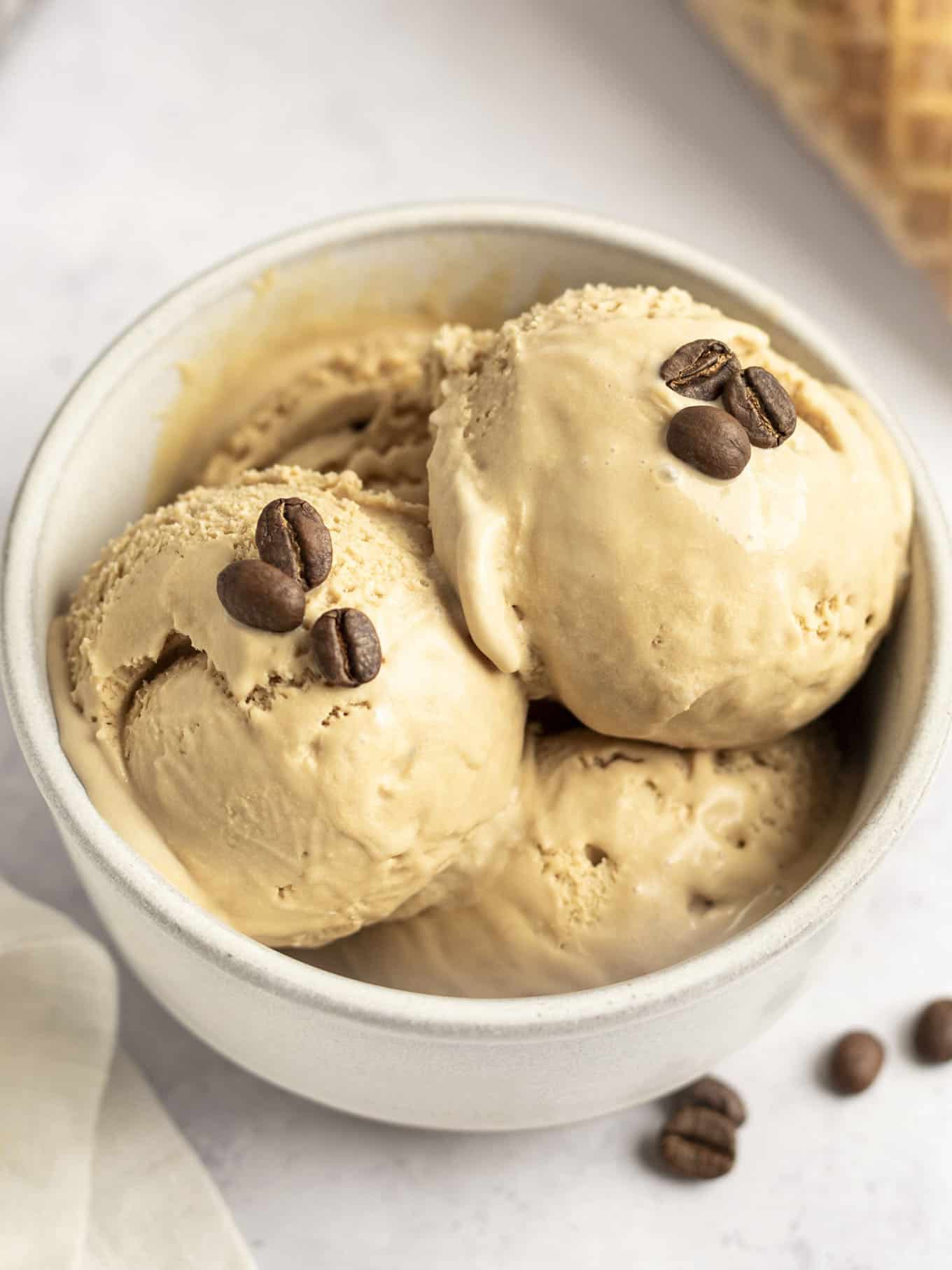 A few scoops of homemade coffee ice cream in a white dish. 