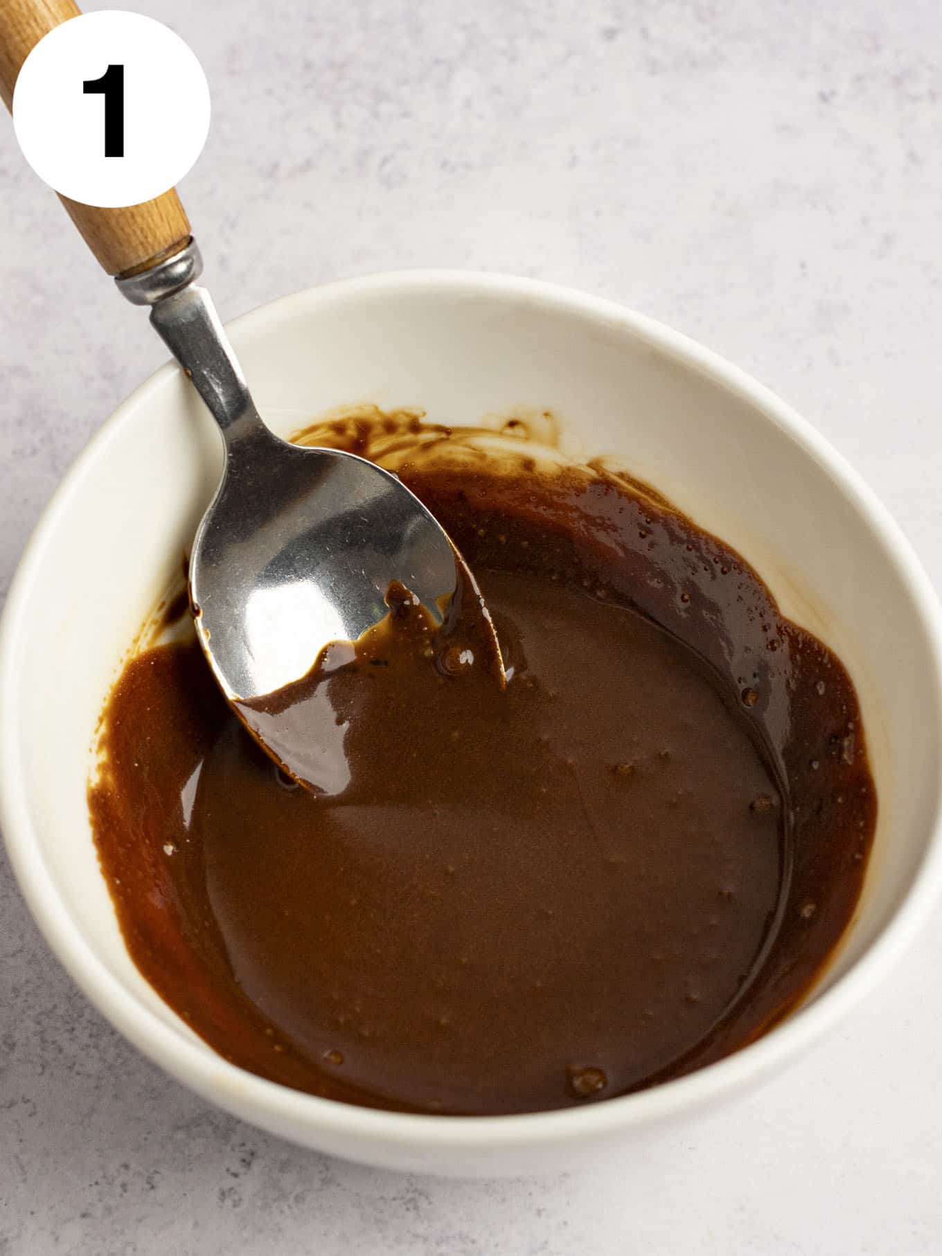 An overhead view of instant coffee and cream mixed in a small dish. 