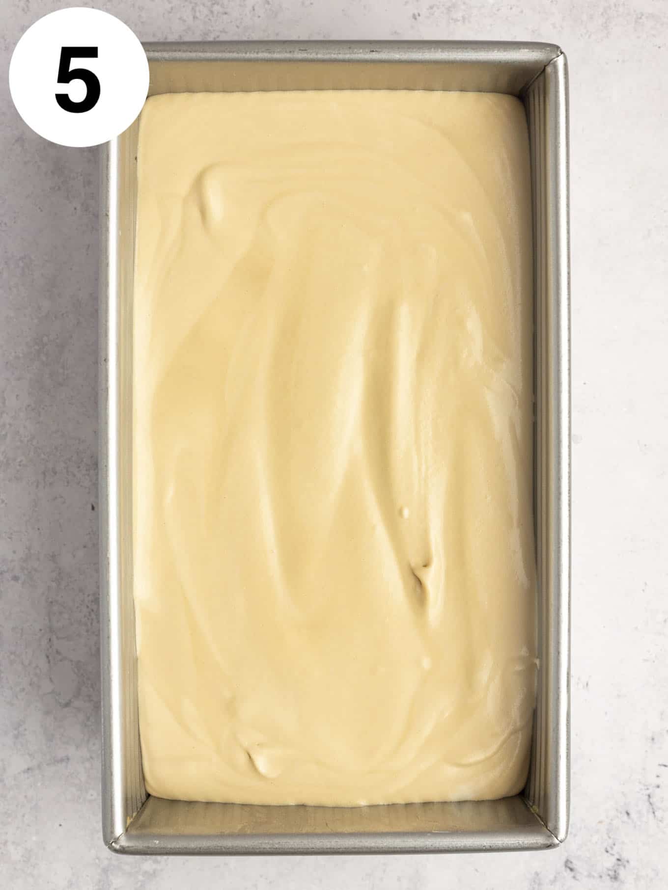 An overhead view of coffee flavored ice cream in a loaf pan. 