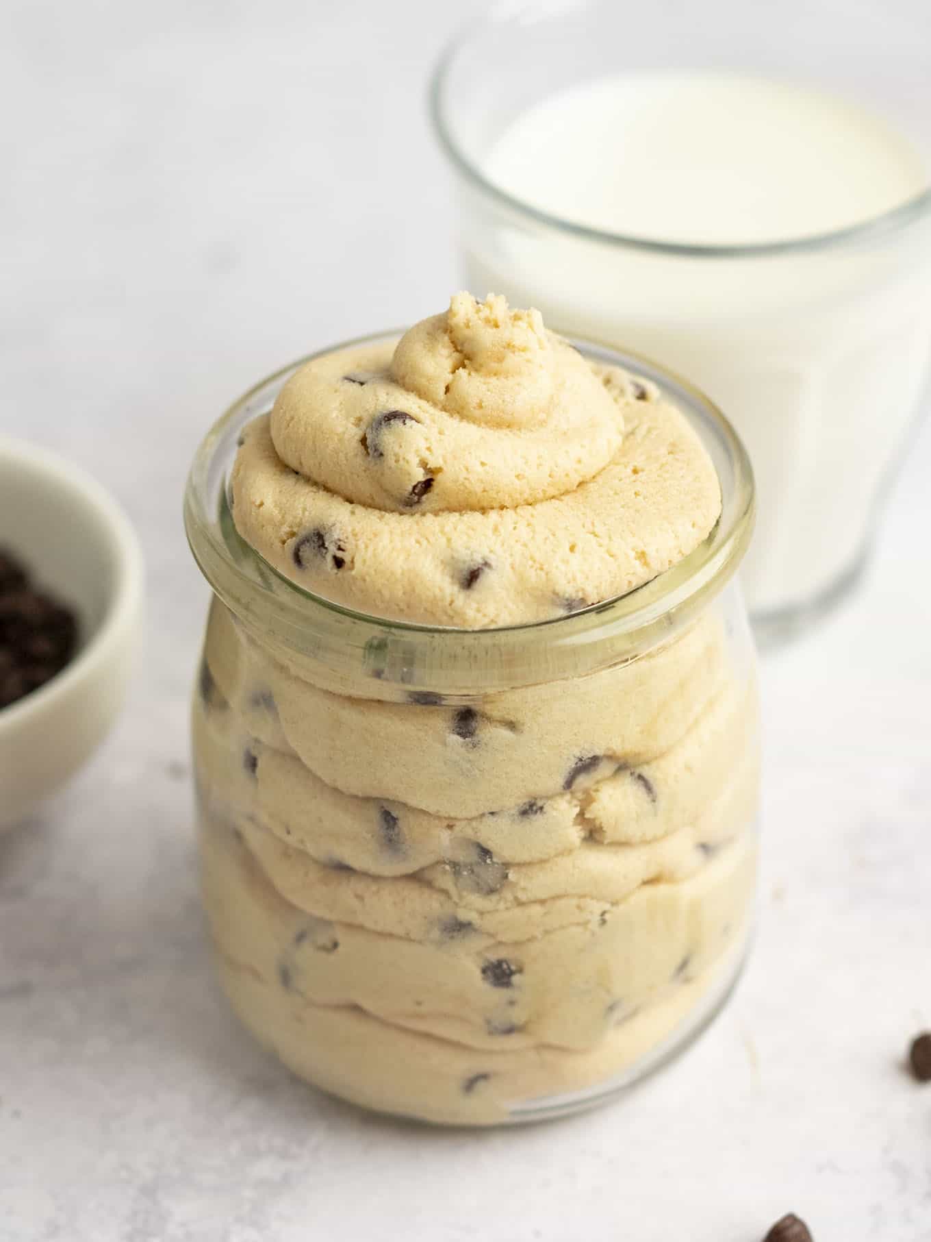 Piped edible cookie dough frosting in a glass jar. 