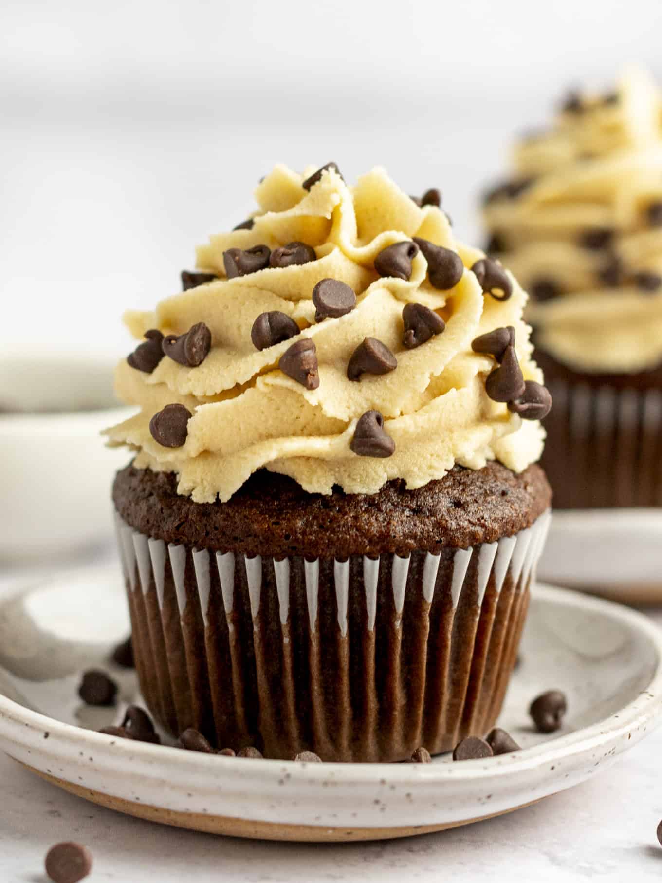 A chocolate cupcake piped with cookie dough frosting.