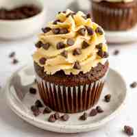 A chocolate cupcake topped with cookie dough frosting.