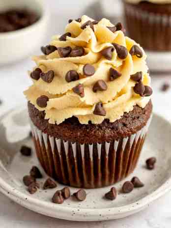 A chocolate cupcake topped with cookie dough frosting.