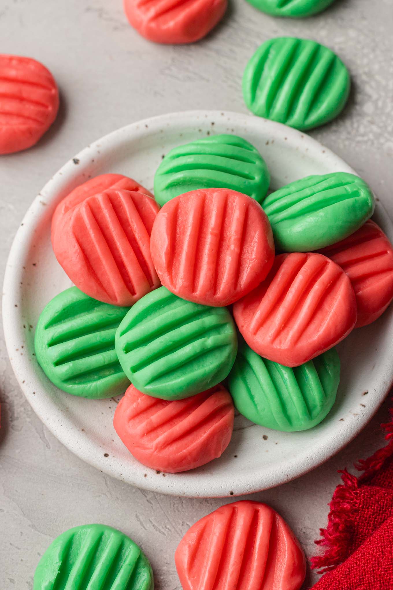 An overhead view of a plate piled high with homemade cream cheese mints.