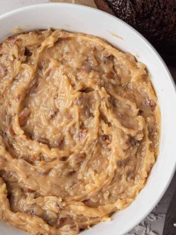 An overhead view of a bowl of German chocolate cake frosting.