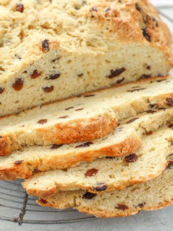 A sliced loaf of Irish Soda Bread on top of an antique round cooling rack.