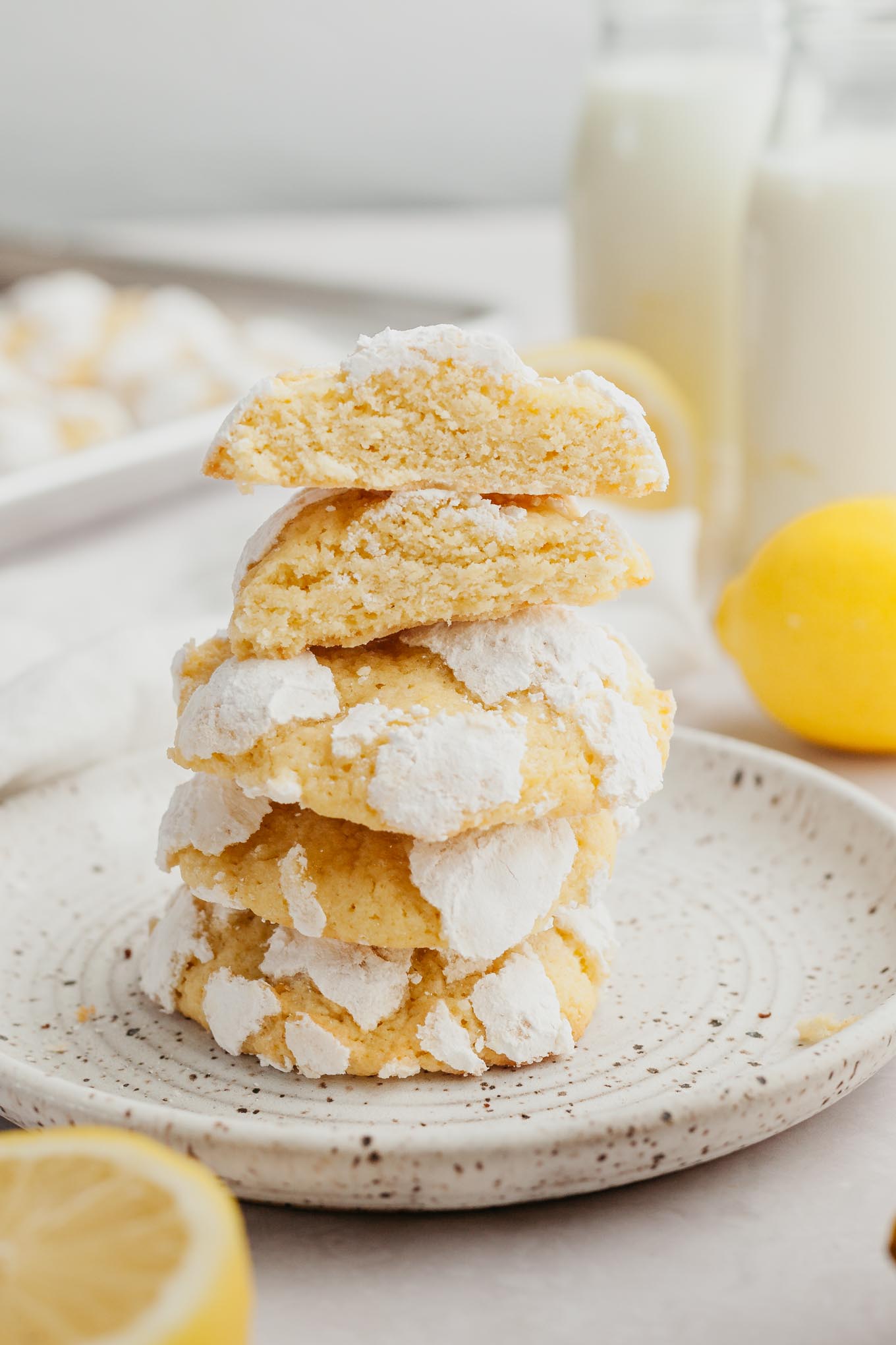 A stack of lemon crinkles on a speckled dessert plate. 