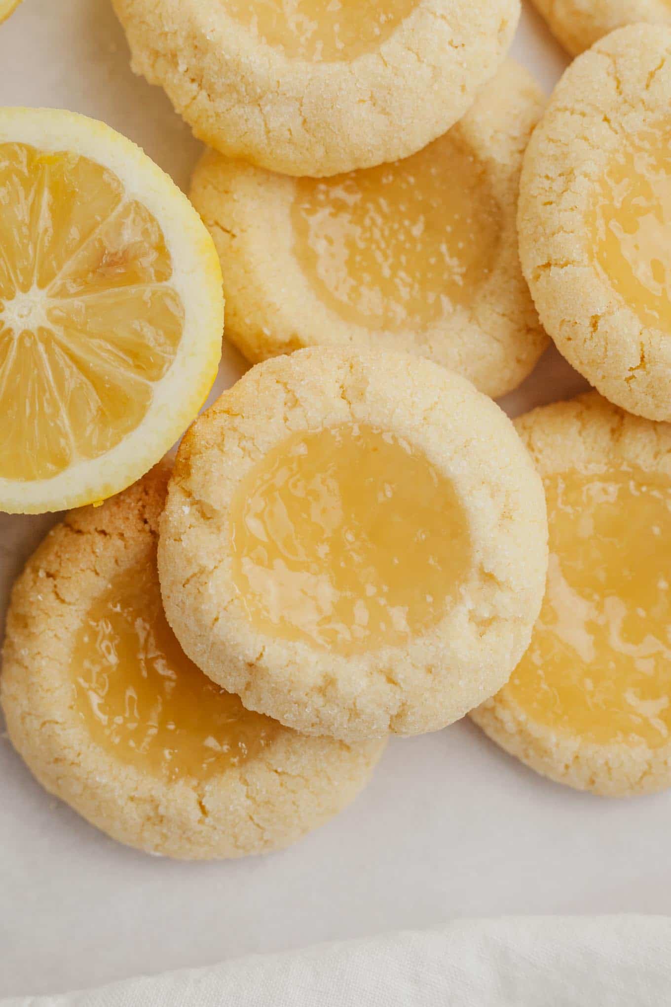 A close-up overhead view of lemon curd filled lemon cookies. 