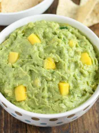 This mango guacamole makes a fun appetizer for any party and comes together in just a few minutes!  Serve it with some tortilla chips for a quick and easy appetizer or snack.