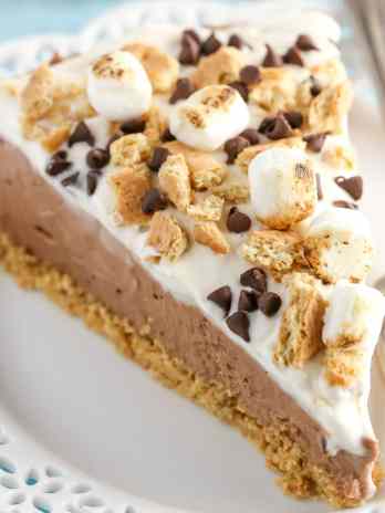A homemade graham cracker crust topped with a no-bake chocolate cheesecake filling and marshmallow fluff whipped cream. This No-Bake S'mores Cheesecake is the ultimate summer dessert!