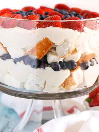 Side view of a large berry trifle in a glass trifle dish.