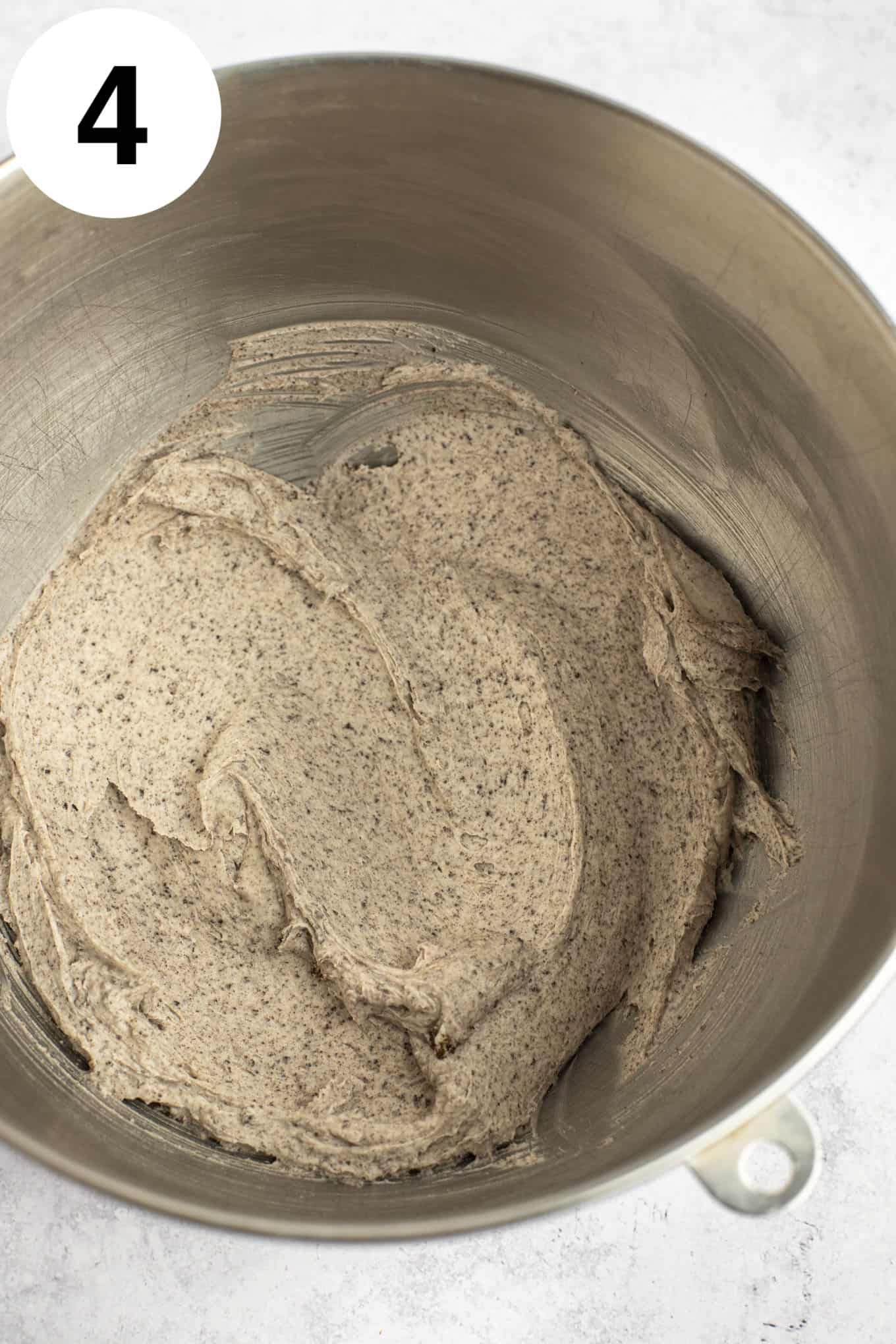 An overhead view of Oreo frosting in a metal mixing bowl. 