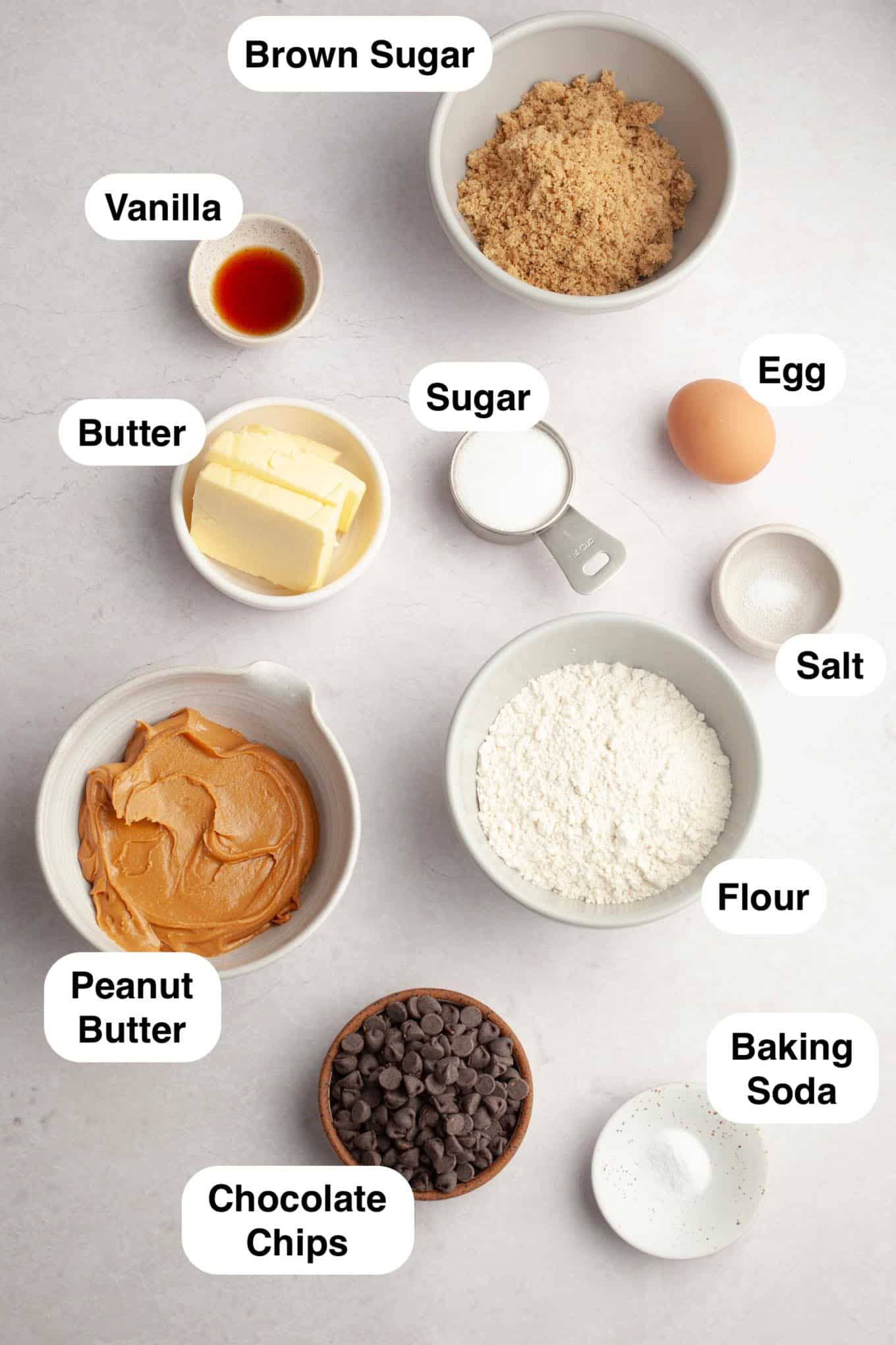 An overhead view of the ingredients needed to make peanut butter cookies with chocolate chips. 