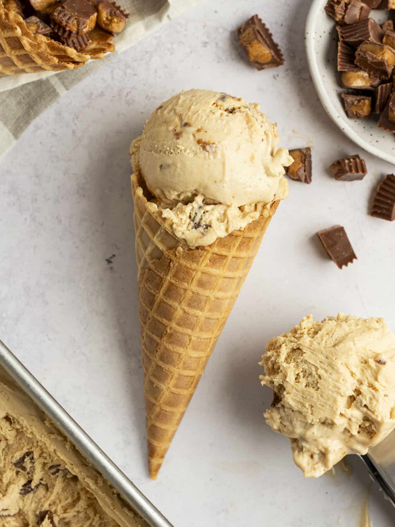 A peanut butter ice cream cone lying on its side.