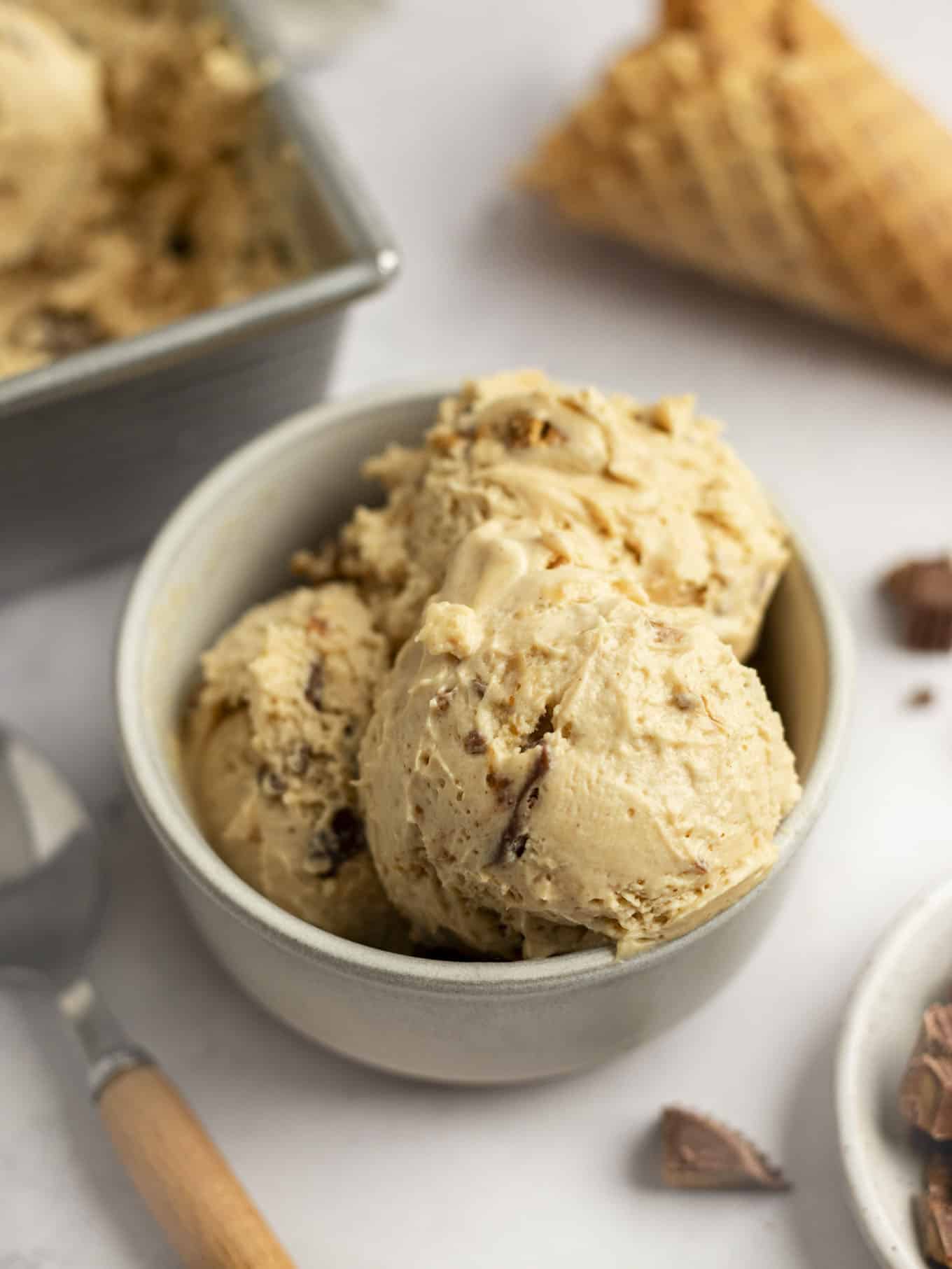 Three scoops of peanut butter ice cream in a small bowl.