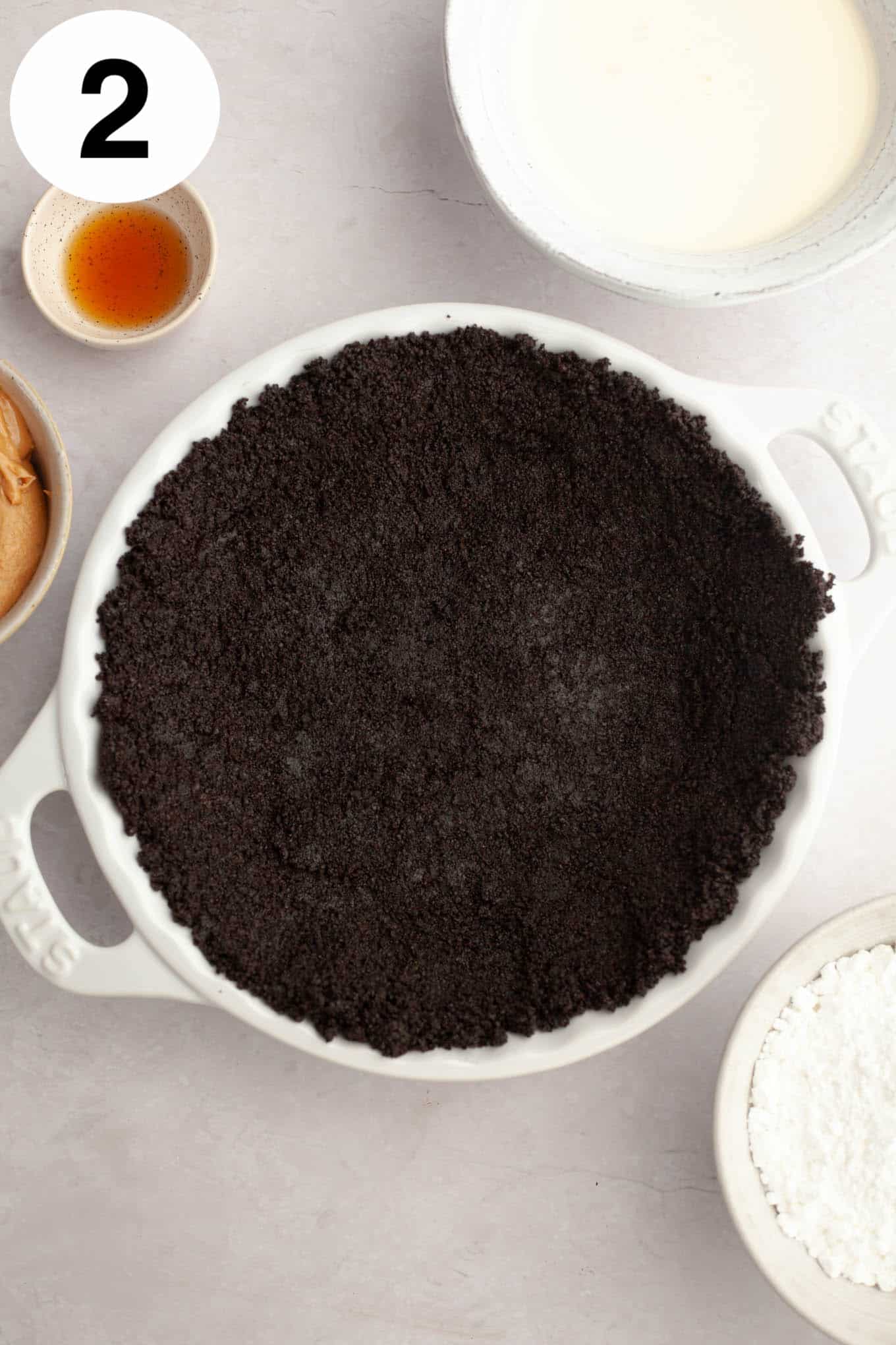 An overhead view of an Oreo crust in a pie plate. 