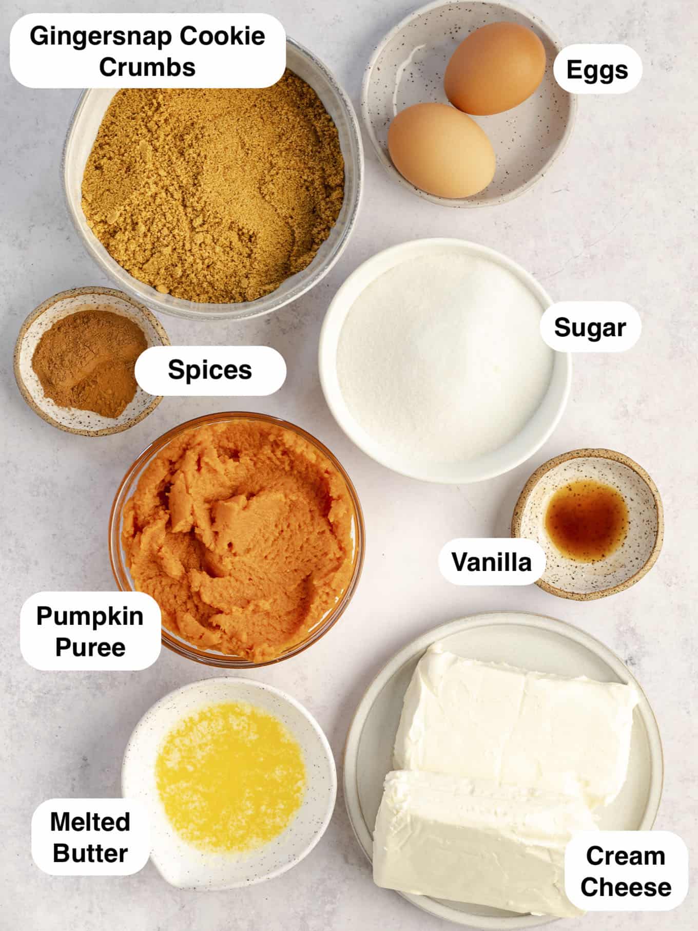 An overhead view of the ingredients needed to make pumpkin cheesecake bars. 