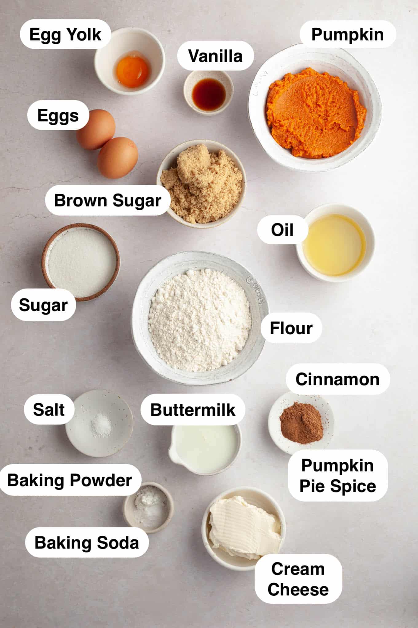 An overhead view of the ingredients needed to make pumpkin bread stuffed with cream cheese. 