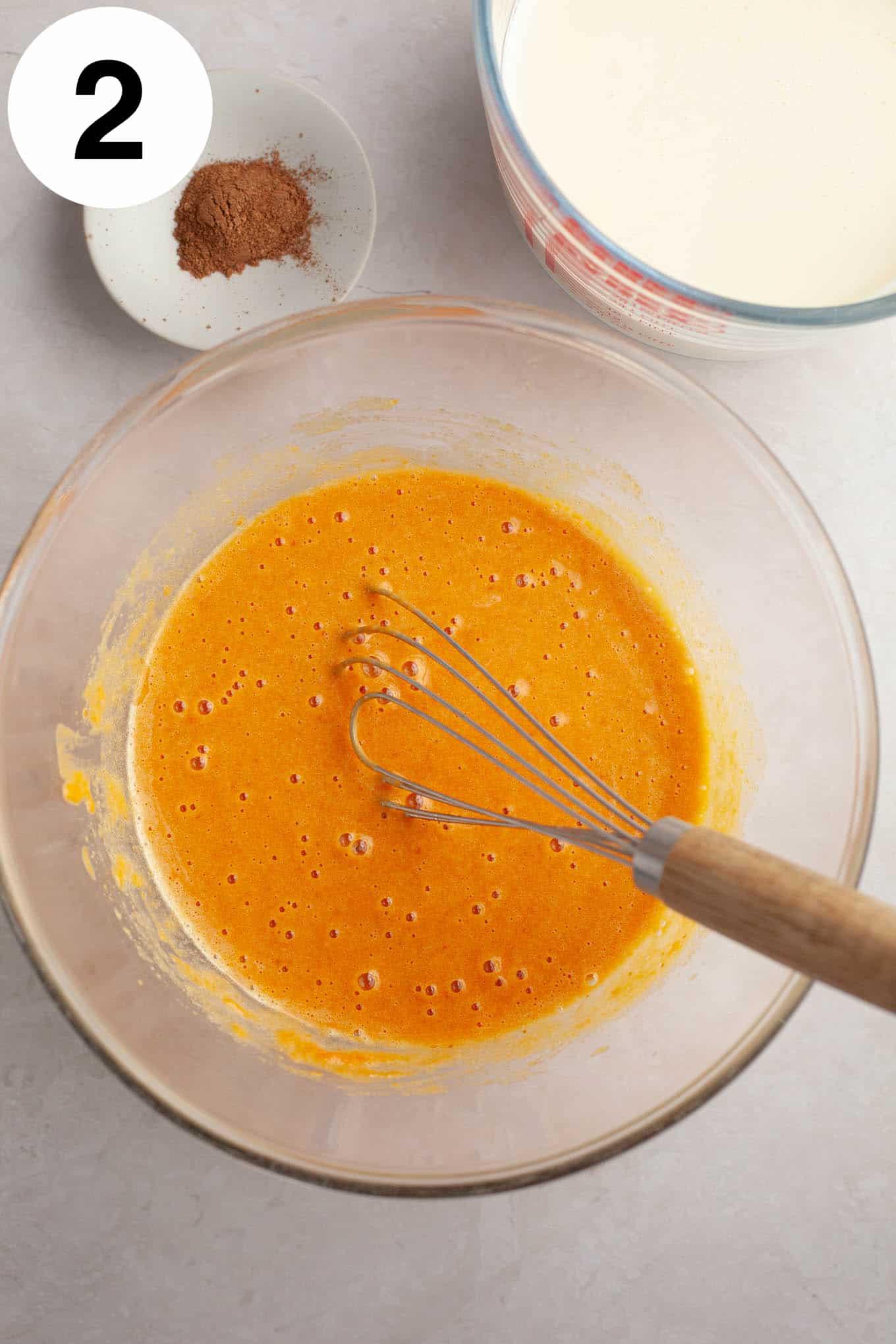An overhead view of a pumpkin and egg yolk mixture. 