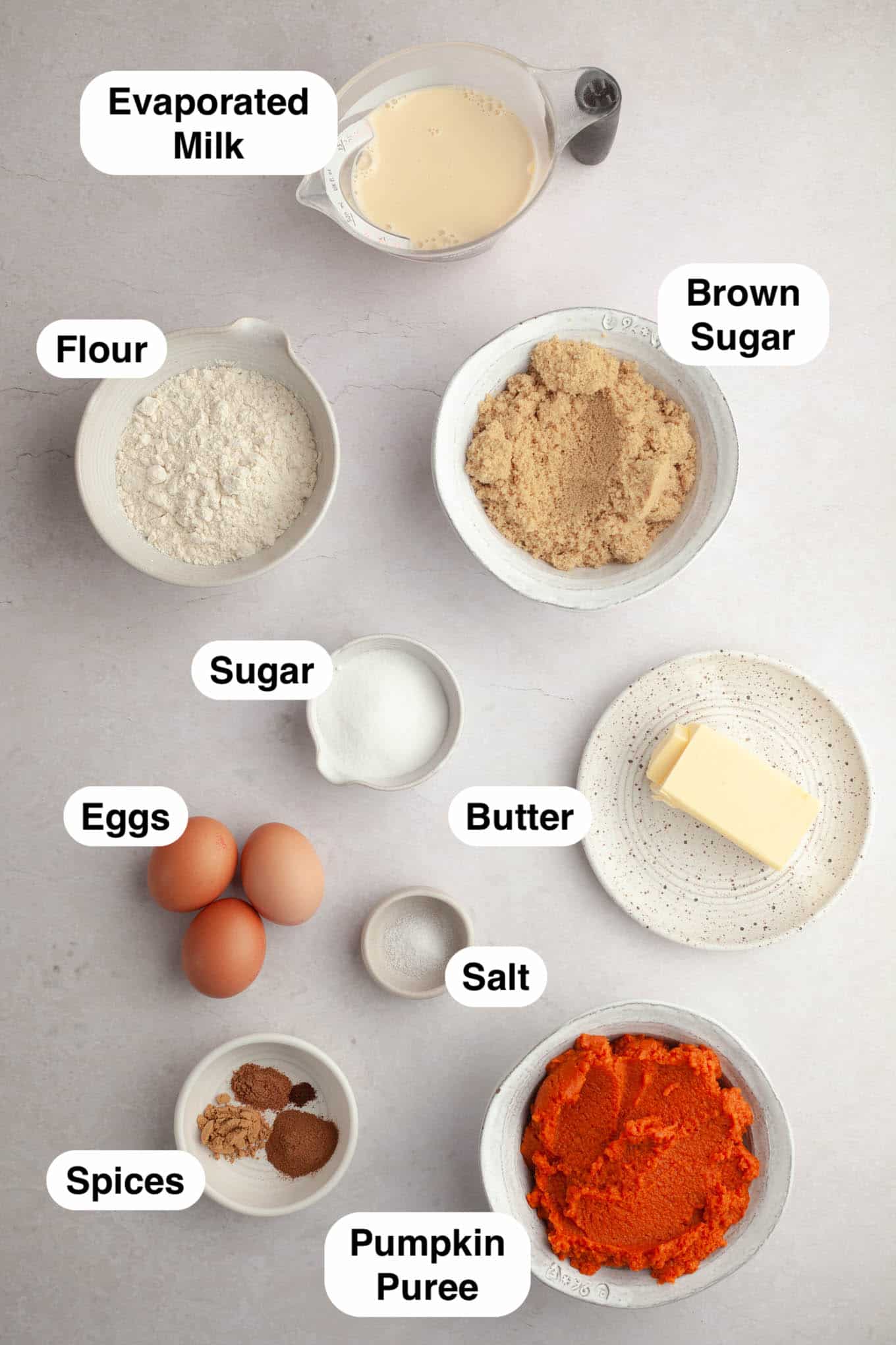 An overhead view of the ingredients needed to make pumpkin pie bars with shortbread crust. 