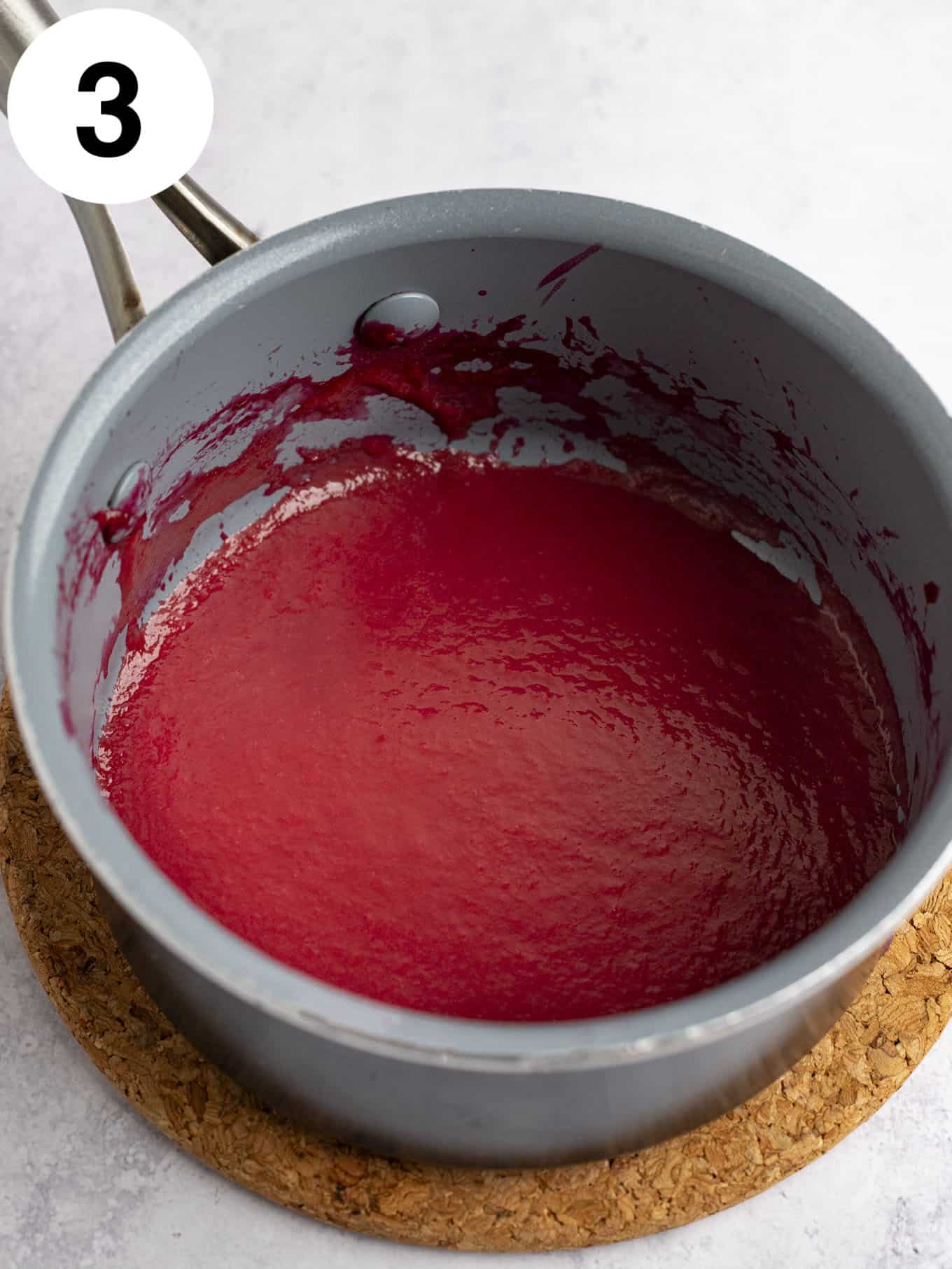 Reduced raspberry puree in a small saucepan. 