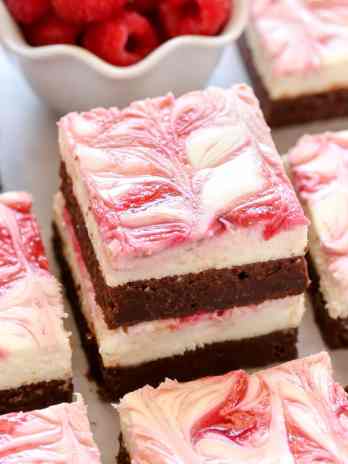A fudgy brownie base topped with a smooth and creamy cheesecake layer and a raspberry swirl. These Raspberry Cheesecake Brownies make a beautiful dessert for any occasion!