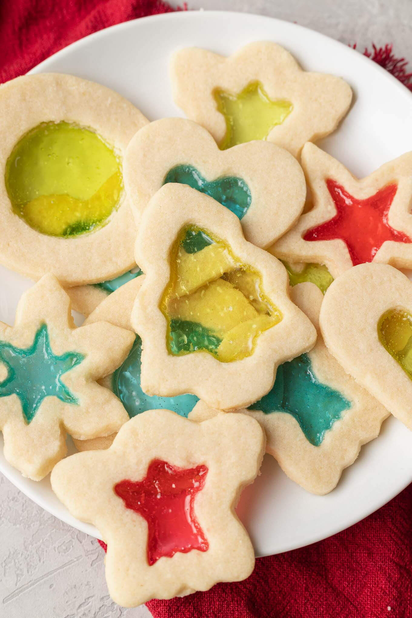 A close-up, overhead view of a plate of stained glass cookies. 