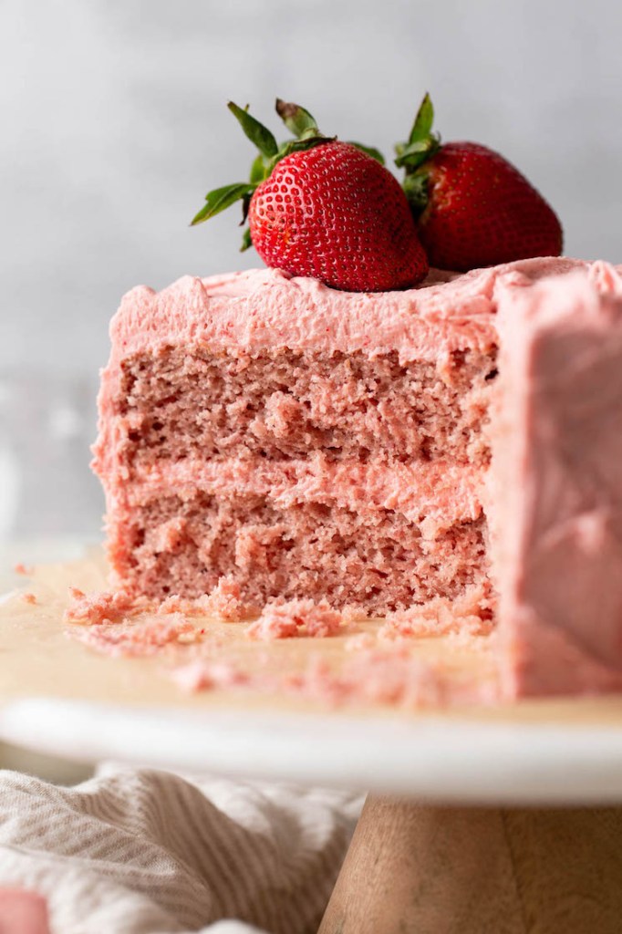 A picture of a sliced strawberry cake showing the inside texture of the cake.